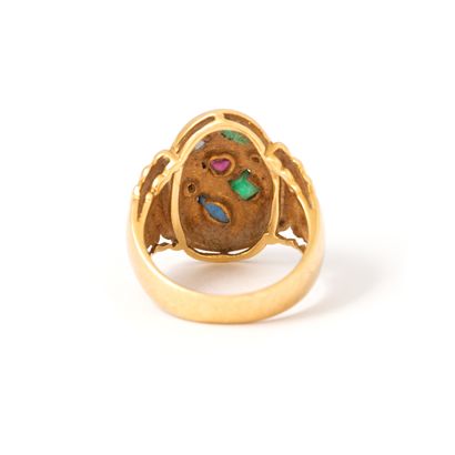 null Ring in 18K yellow gold set with emeralds, sapphires, rubies and diamonds.

Unreadable...