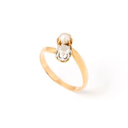null 18K yellow gold ring centered with a rose-cut diamond and a pearl mounted in...
