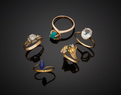 null Lot comprising:

- Three 18K yellow gold 750‰ rings, set with white and green...
