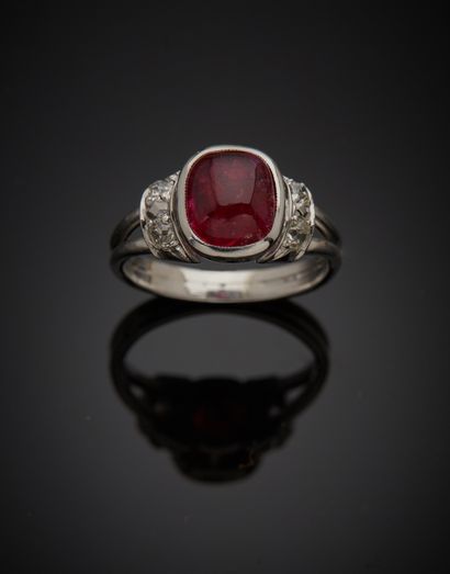 null Platinum 850‰ ring, set with a cushion-shaped cabochon-cut ruby, shouldered...