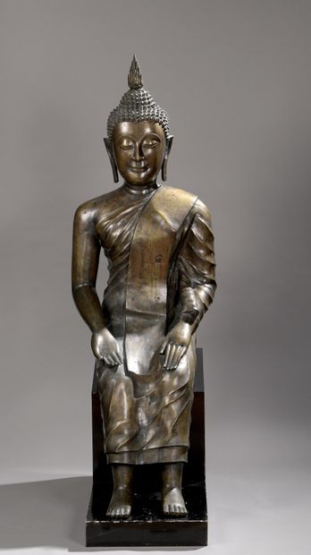 null STATUE in copper alloy, Buddha seated, hands in bhumisparça mudra, dressed in...
