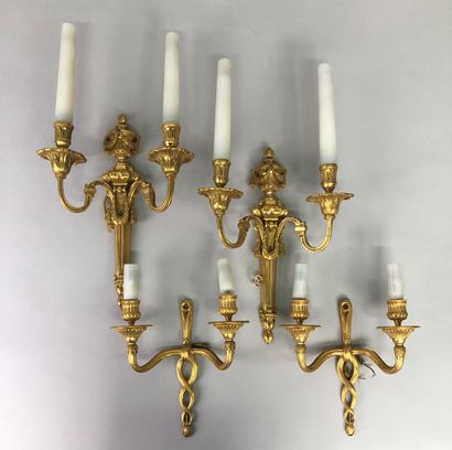 null Two pairs of sconces with two arms of light in chased and gilt bronze, one with...