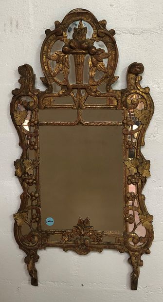 Gilded wood mirror with a fruit bowl decoration....
