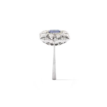 null 18K white gold 750‰ ring centered with an emerald cut blue stone surrounded...
