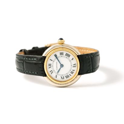 null Cartier. Steel and gilded metal bracelet watch, round shape, white background...