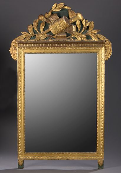 Molded and gilded wood mirror with a pediment...