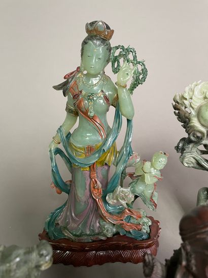 null Lot including:

- Four green hardstone subjects: a polychrome statuette of Guanyin,...