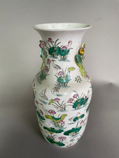 null Porcelain baluster vase decorated in the green family style with cranes in lotuses.

China,...