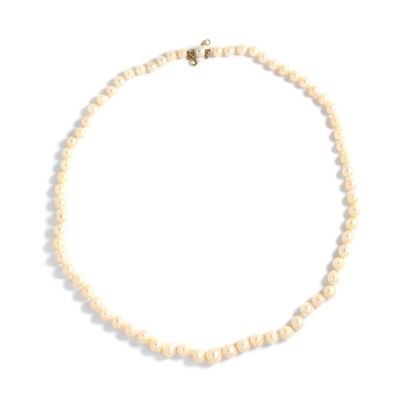null 18K gold 750‰ lot comprising:

- A necklace of falling cultured pearls, mounted...