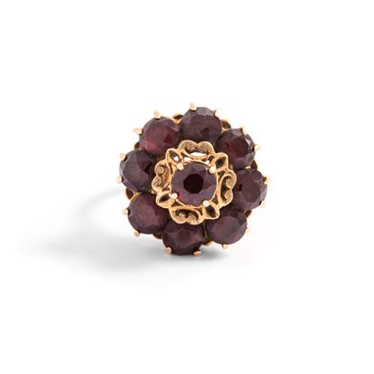 null 18K yellow gold 750‰ flower-shaped ring set with red stones. 

Stones chipped...