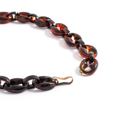 null Pair of tortoise shell bracelets with an anchor chain design, fitted with a...