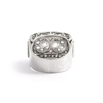 null An 18K white gold 750‰ geometrically patterned ring set with a pavement of old-cut,...