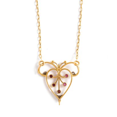 null 18K yellow gold 750‰ and platinum 850‰ necklace, adorned with a scrollwork pendant...
