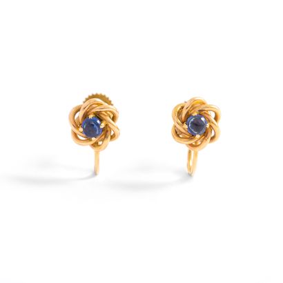 null Pair of 18K yellow gold 750‰ earrings, adorned at their center with a blue cabochon...