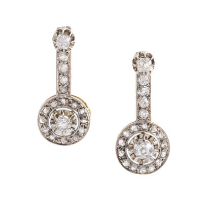 null Pair of 18K two-tone gold 750‰ earrings adorned with a round design topped with...