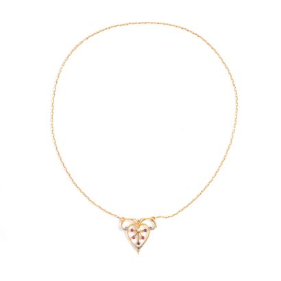 null 18K yellow gold 750‰ and platinum 850‰ necklace, adorned with a scrollwork pendant...