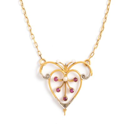 null 18K yellow gold 750‰ and platinum 850‰ necklace, adorned with a scrollwork pendant...