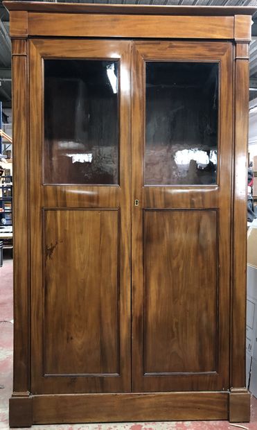 Mahogany cabinet opening with two glass doors...