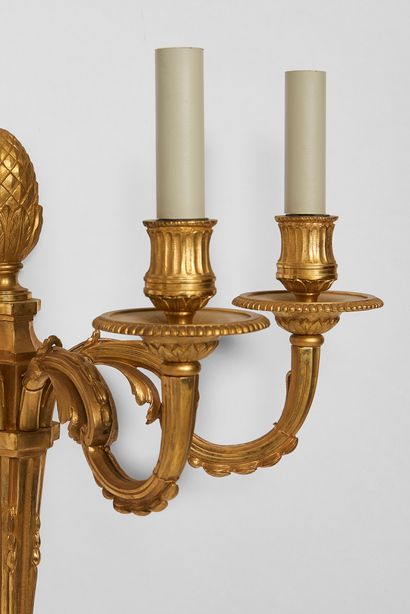 null 
Suite of three sconces with three lights in gilded and chased bronze, fluted...