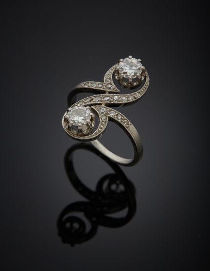 null Platinum 850‰ scroll marquise ring, set with two old and half-cut diamonds,...