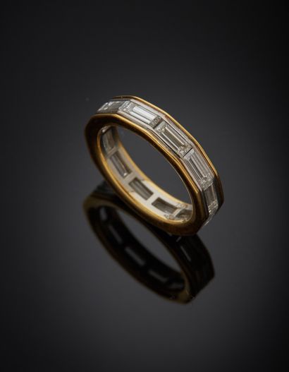 null Two tone 18K gold 750‰ wedding band, set in a rail of baguette cut diamonds....