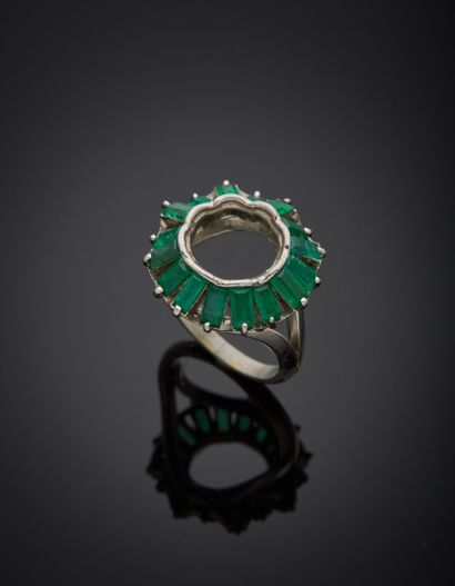 null Platinum 850‰ setting, round in shape, skirted with rectangular-cut emeralds....