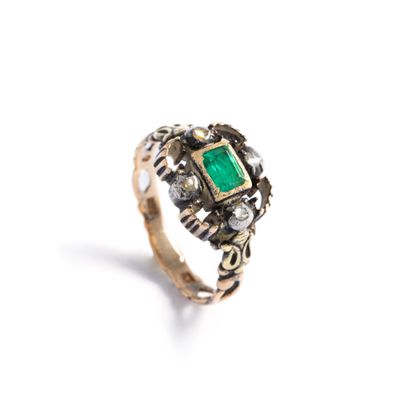 null 18K gold 750‰ and silver 800‰ ring centered with a green stone surrounded by...