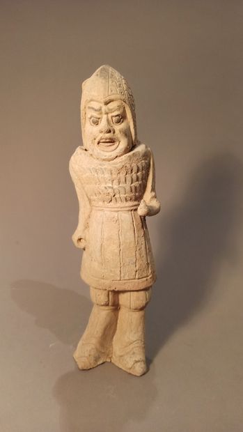 null Terracotta statuette representing a warrior in armor and helmet, mouth open....