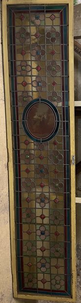 null Two doors decorated with stained glass windows with characters in the 18th century...