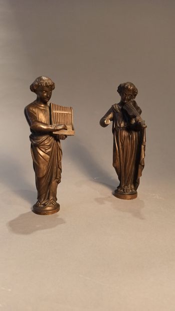 null Two statuettes in patinated bronze representing musicians, one playing the lyre,...