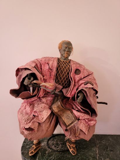 null Japanese doll depicting a seated samurai, the clothes in silk (missing, torn),...