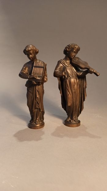 null Two statuettes in patinated bronze representing musicians, one playing the lyre,...