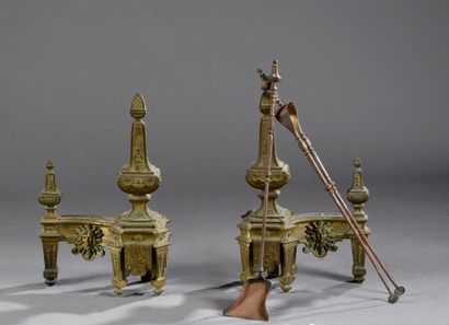 null Pair of gilt bronze andirons decorated with balusters, radiating suns and foliage.
Louis...