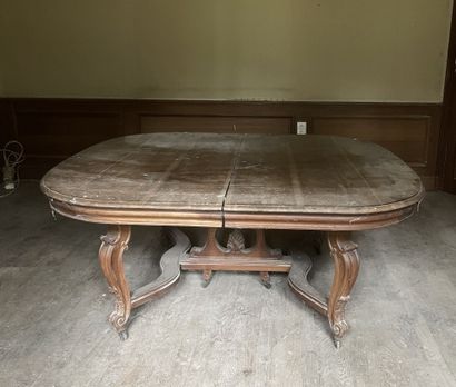 null Dining room table with extensions. Curved legs with casters joined by a strut.
Louis...