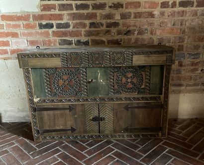 null Small sideboard in stained wood and carved with geometric patterns. It opens...