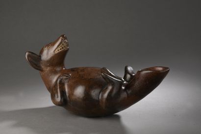 null CEREMONIAL VASE representing a dog.
Lying on its back and paws in the air, it...