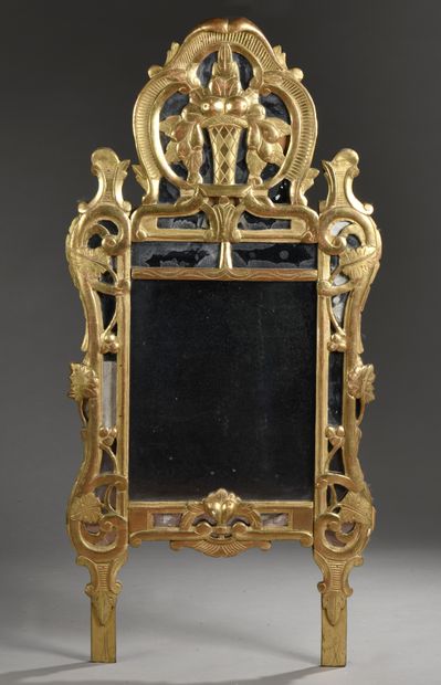 null MIRROR in a carved and gilded wood frame decorated with flowering vases, scrolls,...