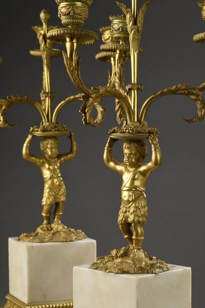 null PAIR OF CANDELABRES in gilt bronze and white marble decorated with a young African...