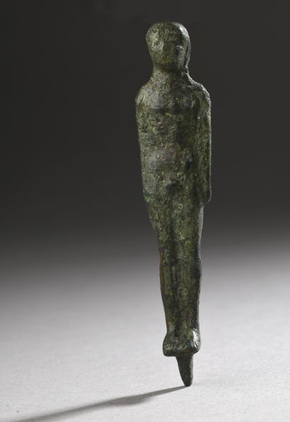 null Anthropomorphic STATUTE representing a standing kouros, arms along the body....