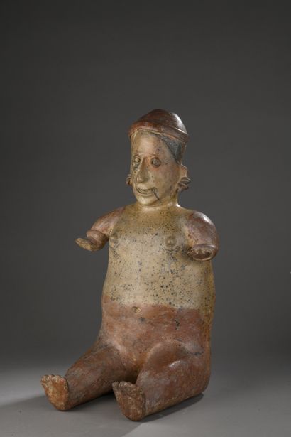 null SEATED WOMAN.
The face is in the Jalisco style with a long nose and eyes in...