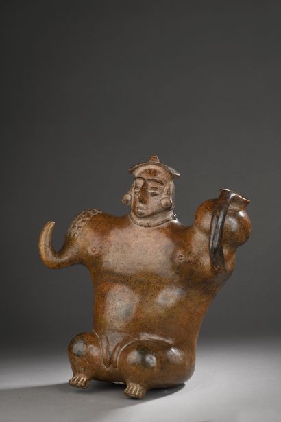 null JUG CARRIER.
This seated figure with broad shoulders carries a jug on his left...