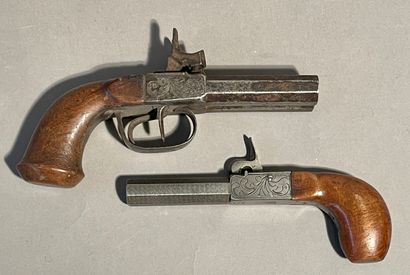 Two percussion pistols, one with double barrel...