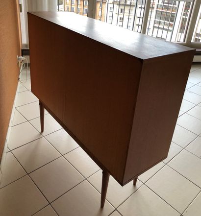 null Teak sideboard opening with a leaf, a flap and two drawers. Tapered legs.
Work...