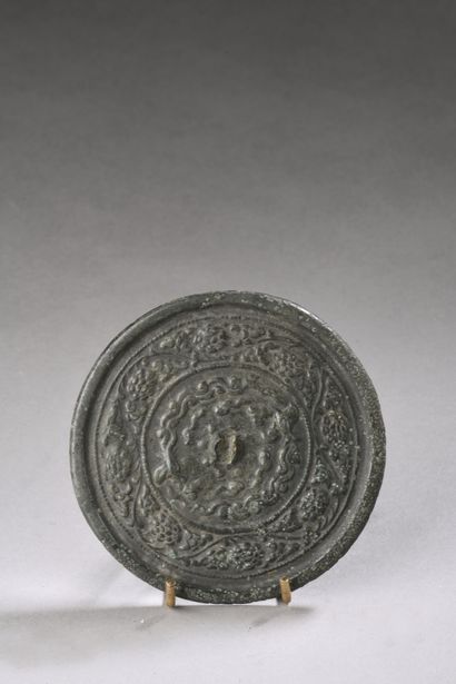 null Bronze mirror, the reverse side decorated with phoenixes among clouds, surrounded...
