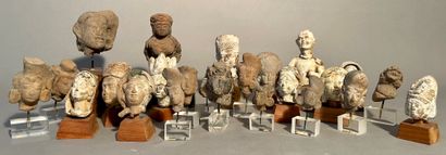 Set of 24 terracotta or stucco heads, Islamic...