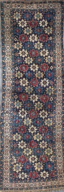 null Chirvan carpet in wool decorated with a seedling of flowers on a midnight blue...