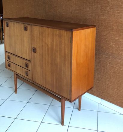 null Teak sideboard opening with a leaf, a flap and two drawers. Tapered legs.
Work...
