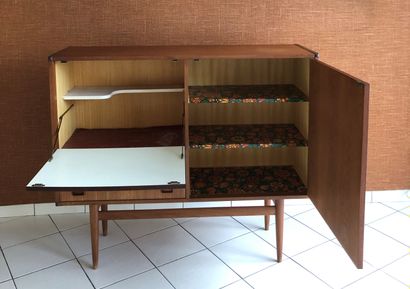 null Teak sideboard opening with a leaf, a flap and two drawers. Tapered legs.
Work...