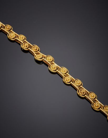 null Bracelet en or jaune 18K 750‰, articulé, composé de deux lignes de fleurettes...