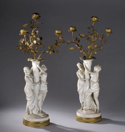 null Paire de candélabres à trois bras de lumière en biscuit et bronze doré.


Base...